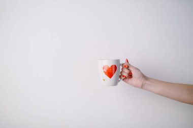 woman holding  cup  with heart shape clipart
