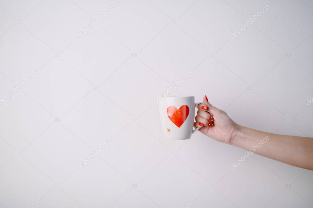 woman holding  cup  with heart shape