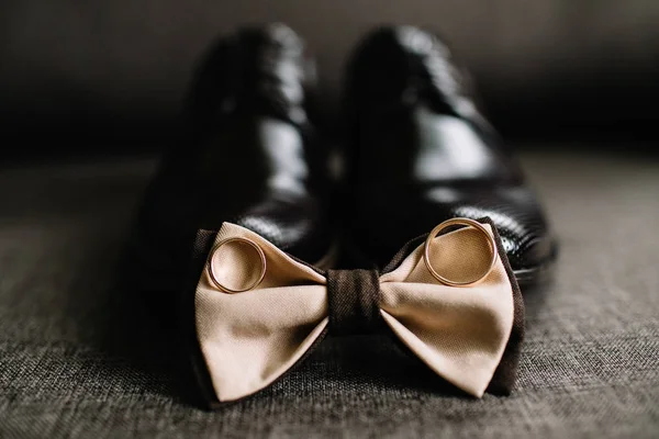 Wedding details. Groom accessories. Shoes, rings, and bowtie