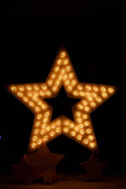 Decorative star with lamps in room clipart