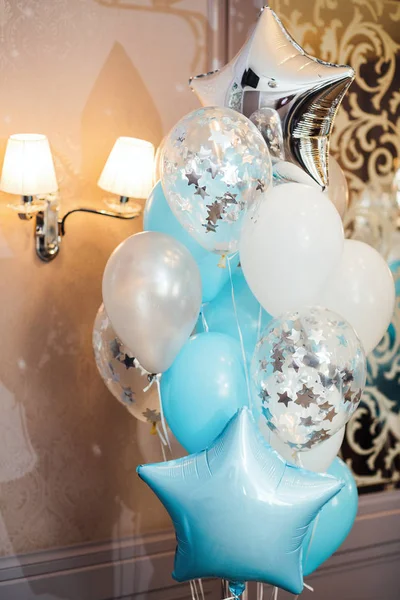 birthday photo zone with white, blue and transparent balloons, free space. Colorful balloons background,