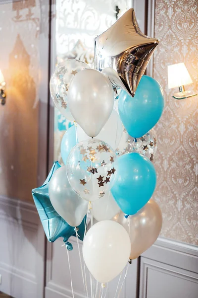 birthday photo zone with white, blue and transparent balloons, free space. Colorful balloons background,
