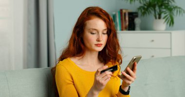 Akıllı telefondan alan ve kredi kartıyla ödeyen güzel kız, evde kal..