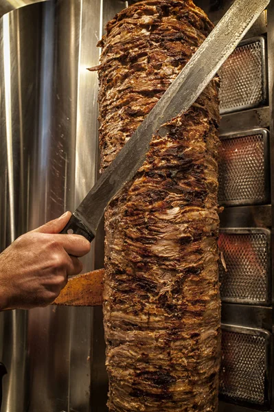 man cutting meat in doner cafe