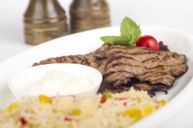 close-up shot of delicious grilled steaks with rice on place
