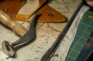 close-up of a man's hands with a knife. Leather craftsman