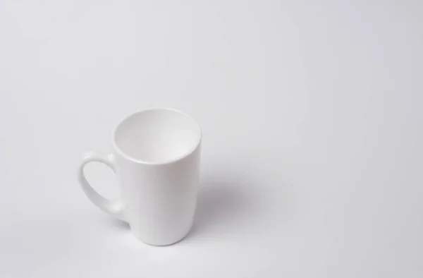 White cup on white background — Free Stock Photo