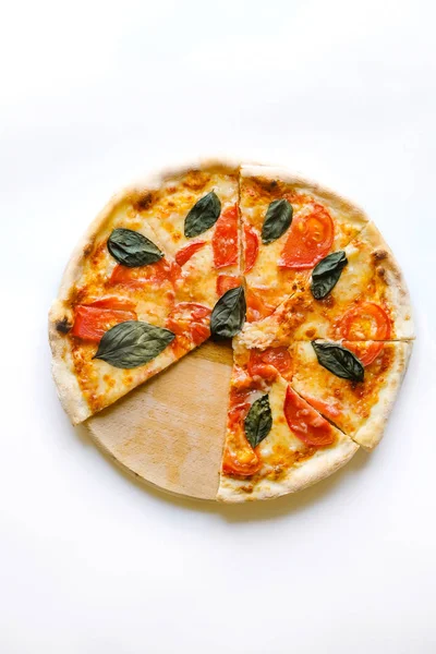 tasty vegetable pizza on desk board on white background