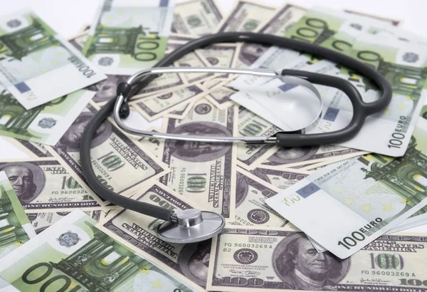 medical stethoscope on dollars and euro banknotes.coronavirus