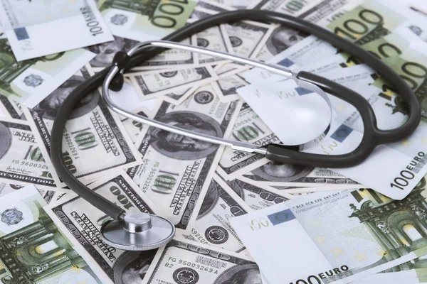 medical stethoscope on dollars and euro banknotes.coronavirus