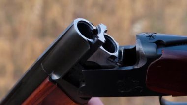 The hunter charges the rifle.Male hunter ready to hunt with hunting rifle.slow motion