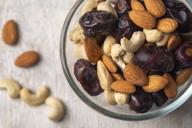 Beyaz ahşap arka planda fındık ve hurma karışımı. Üst görünüm. Sağlıklı yemek.