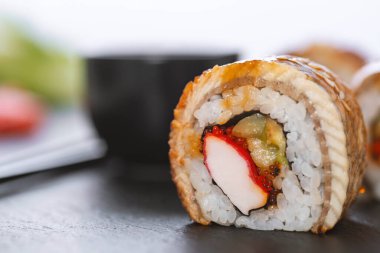 Pilavlı suşi, yengeç, salatalık, avokado, tobiko, yılan balığı. Suşi menüsü. Japon yemeği..