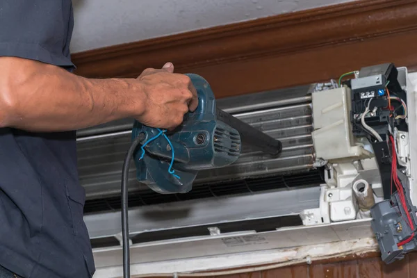 Man use blower cleaning air conditioner