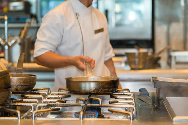 Chef cocina con sartén en la cocina — Foto de Stock