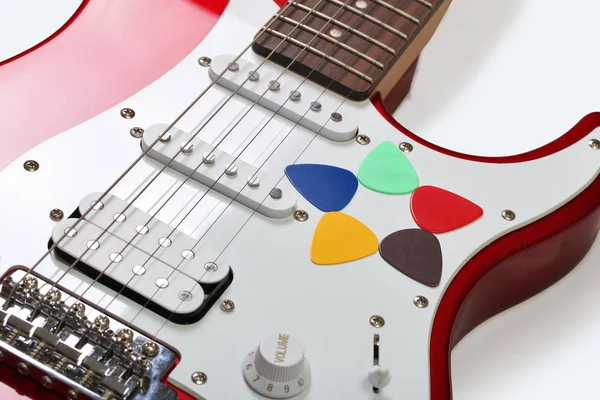 Five colored picks on a guitar on a white background — Stock Photo, Image