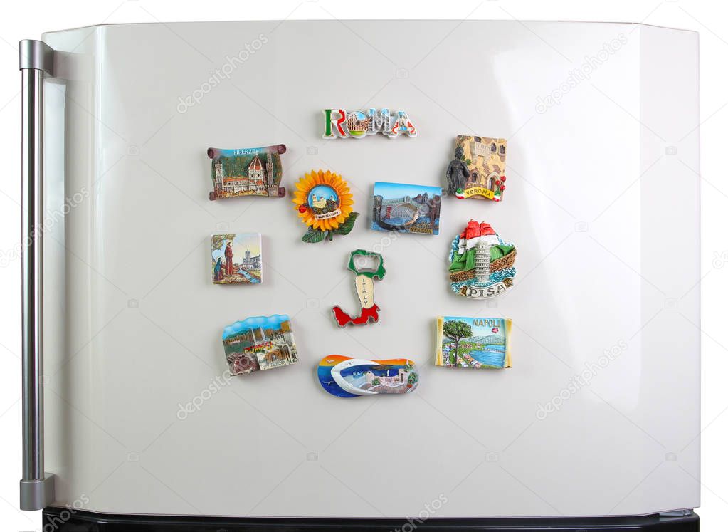 Souvenir magnets of the cities of Italy on the door of the refri