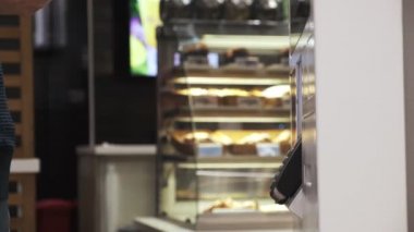 Genç bir adam telefon satın alır. Ulaşılmaz bir şekilde, self servis makinesinden. Erkekler telefonla öder. Kapat. 4k Video 