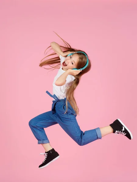 Dancing and singing. Teenager listen music. Recommended music based initial interest. Free music apps for mobile device. Energetic playlist. Girl cute schoolgirl white clothes headphones listen music.
