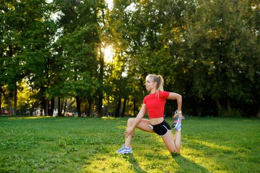 Doğada yaşayan genç bir kız parkta yoga dersleri alıyor..