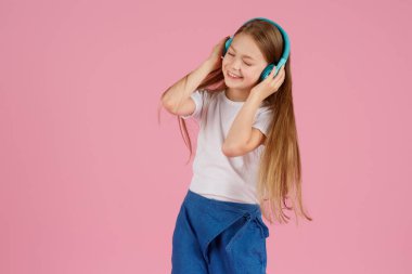 Dans ve şarkı. Gençler müzik dinler. İlgiye dayalı müzik önerildi. Mobil cihaz için bedava müzik uygulamaları. Enerjik çalma listesi. Güzel liseli kız beyaz kulaklıklar müzik dinliyor..