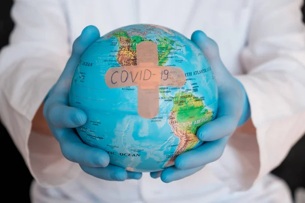World globus with green medical mask on it. Coronavirus epidemic concept. Concept for world wide spread of Coronavirus desease..