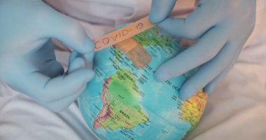 Mavi arka planda izole edilmiş tıbbi elbise, steril yüz maskesi eldivenli erkek doktor görüntüsü. Salgın hastalıklar.