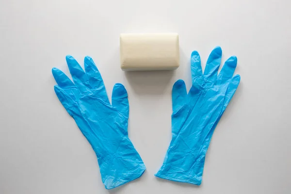 Pair of latex medical gloves, medical masks, sanitizer gel for hand hygiene, remedies, soap, disinfector. Coronavirus prevention