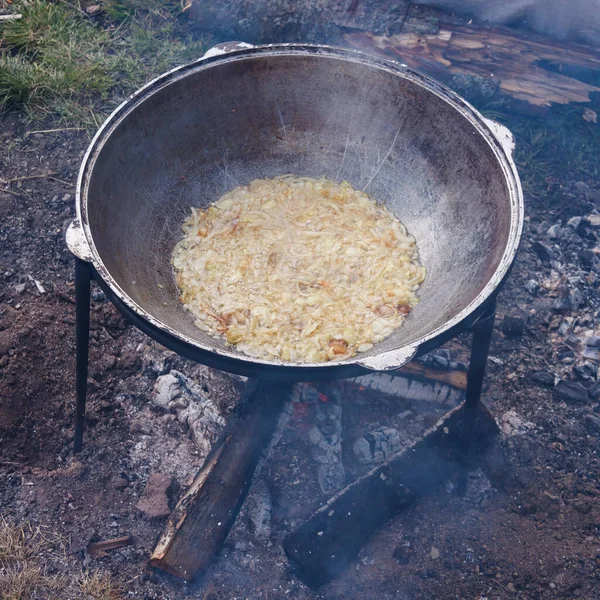 A series of the process of cooking pilaf in a cauldron on the st — 스톡 사진