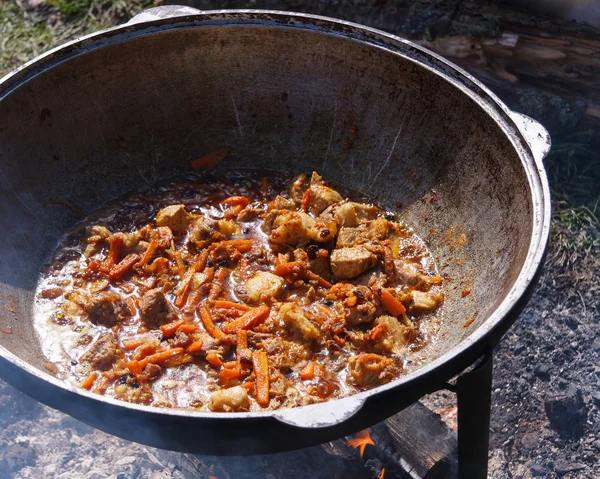 A series of the process of cooking pilaf in a cauldron on the st — 스톡 사진