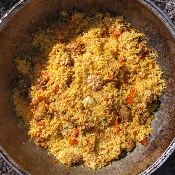 A series of the process of cooking pilaf in a cauldron on the st — 스톡 사진