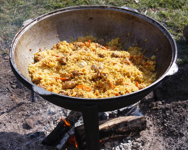 A series of the process of cooking pilaf in a cauldron on the st — 스톡 사진
