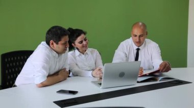 Takım üç beyaz iş adamları bir modern ofis Yönetim Kurulu Toplantı şehir giysili. Onlar için onların iş geliştirme fikirleri görüşüyorlar.