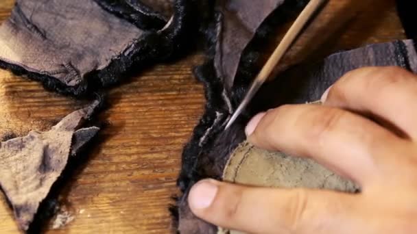 Le chapelier fonctionne. Processus de fabrication de chapeaux. Chapeau Astrakhan en laine et cuir d'origine. Chapeau Astrakhan et manteau en feutre. Cisailles de chapelier concept sur la texture en bois .