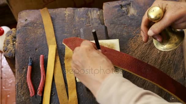 Z'n. Zadel vervaardiging. Lederen goederen ambachtsman op het werk in zijn werkplaats. Artisan leder. Zadel crafting. Oude vintage art. De leer van het traditionele naaien tot het punt van het zadel. Azerbeidzjan oude kunst. — Stockvideo