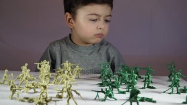 beş yaşında bir çocuk oyuncak askerlerle oynayan