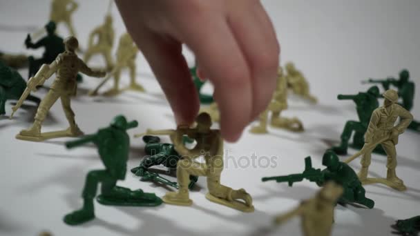 Пятилетний мальчик играет с игрушечными солдатиками — стоковое видео