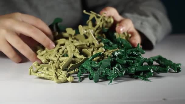 Five year old boy playing with toy soldiers — Stock Video