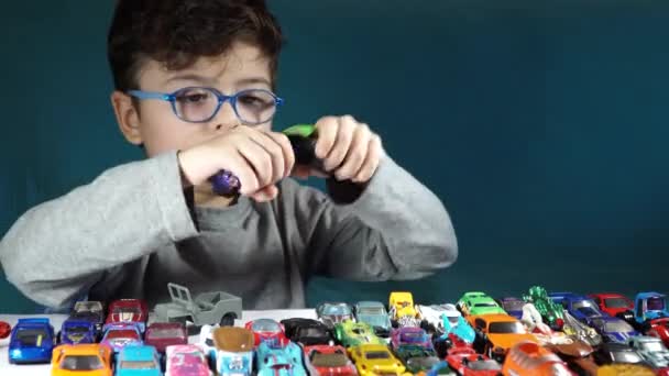 Menino de cinco anos brincando com carros de brinquedo — Vídeo de Stock