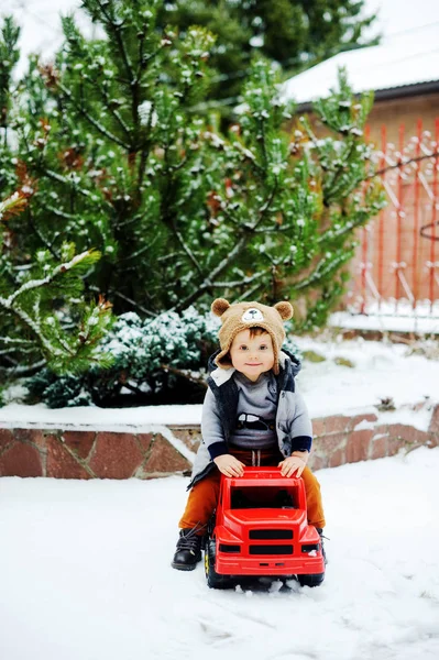 Baby boy and toy car in winter — Stock Photo, Image