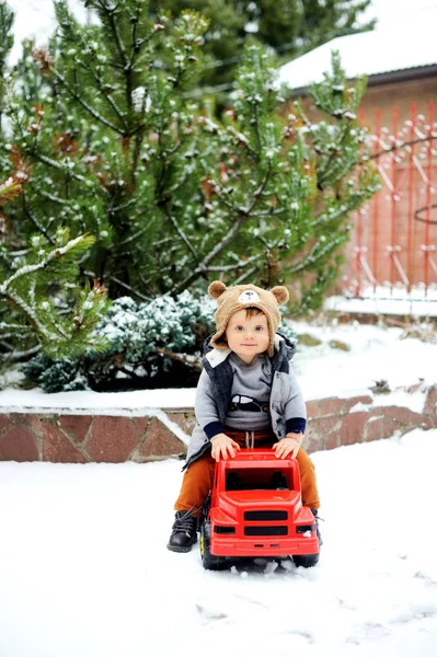 Baby boy and toy car in winter — Stock Photo, Image