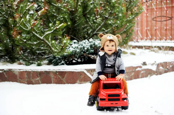 Baby boy and toy car in winter — Stock Photo, Image