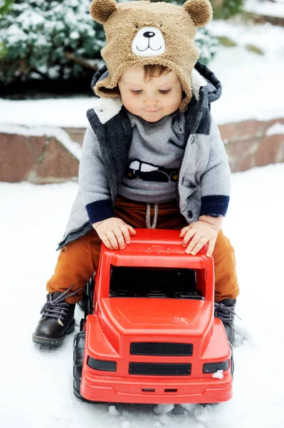 Baby boy and toy car in winter — Stock Photo, Image