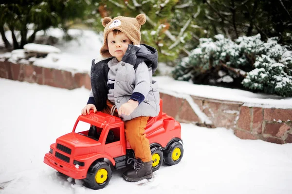 Baby boy and toy car in winter — Stock Photo, Image