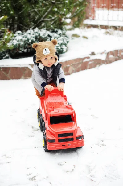Baby jongen en speelgoed auto in de winter — Stockfoto