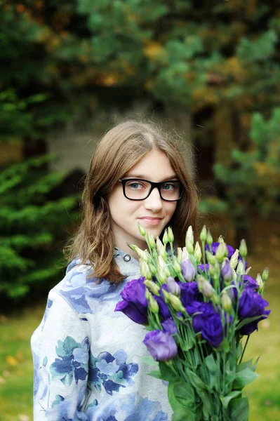 Belle jeune fille avec un bouquet de fleurs — Photo