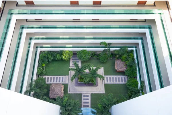 Hotel courtyard with grass lawn and balcony