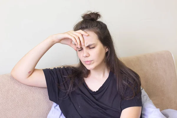 Sjuk ung kvinna sitter hemma med svår huvudvärk — Stockfoto