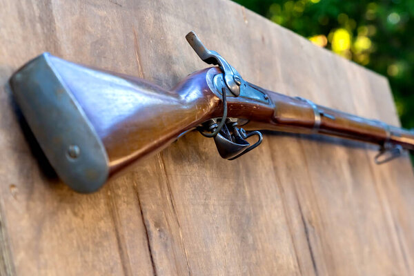 close-up musketry weapon on wooden butt butt, medieval firearms weapon