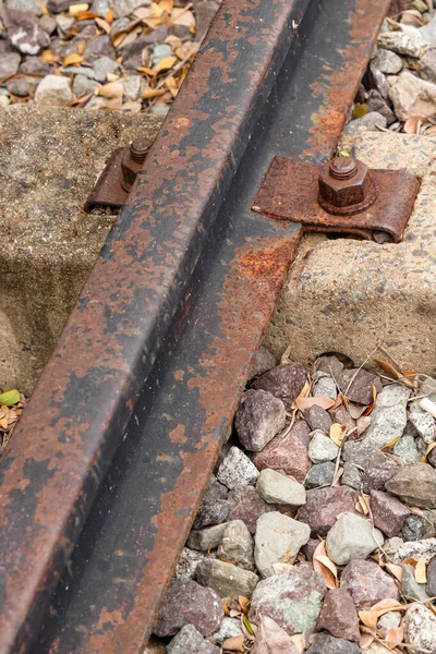 stock image abandoned railroad track, rusty old rail closeup on gravel background